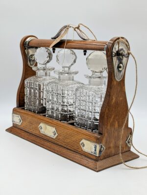 Edwardian Oak Tantalus with Three Cut Crystal Decanters and Working Key