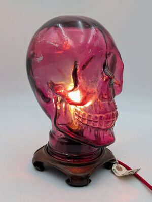 Illuminated Cranberry Glass Skull Lamp on Wooden Base